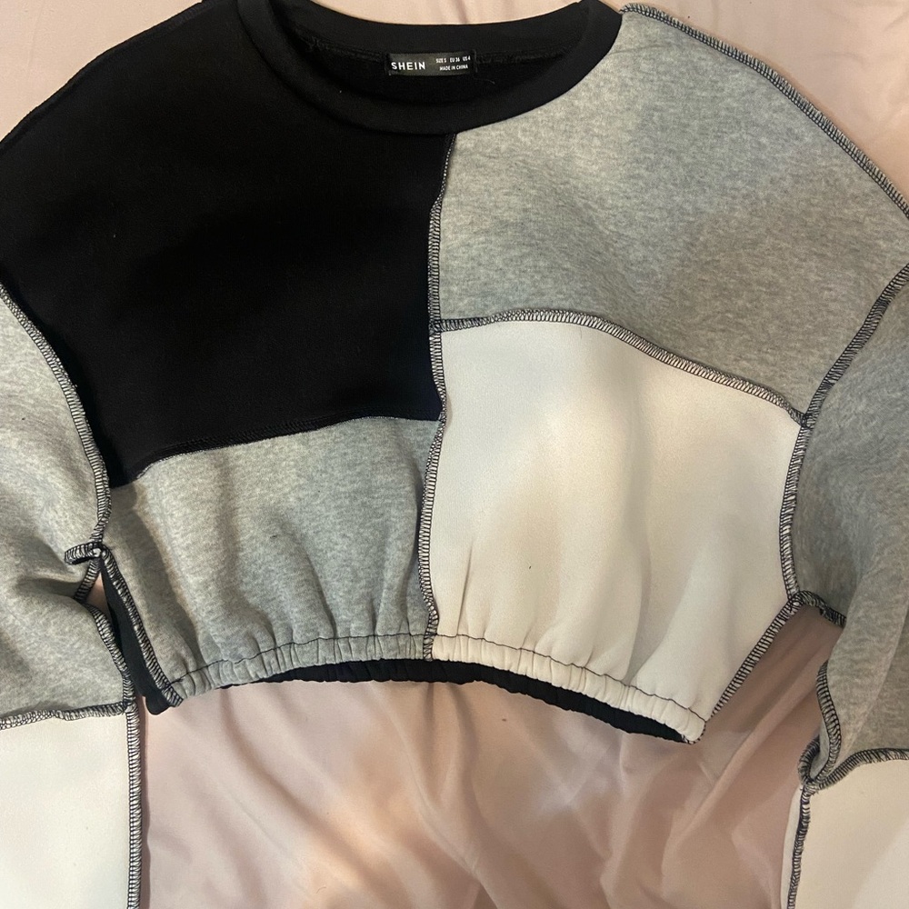 black , white , and grey color block cropped sweater
